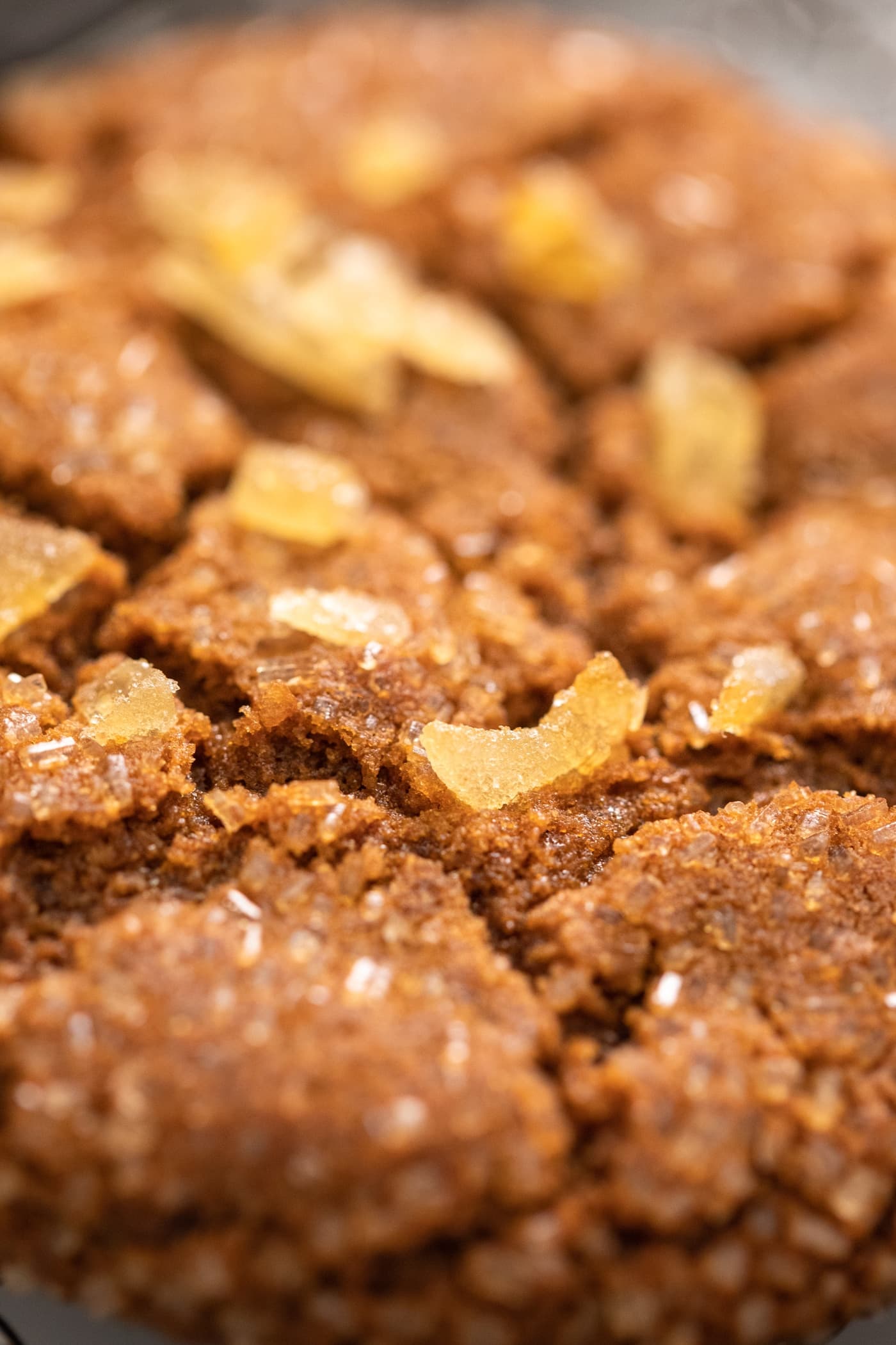 Close up view of molasses cookie with pieces of candied ginger on top