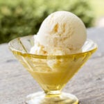 A scoop of vanilla ice cream in a dish.