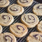 Peanut butter rollup cookies sitting on cooling rack after coming out of the oven.