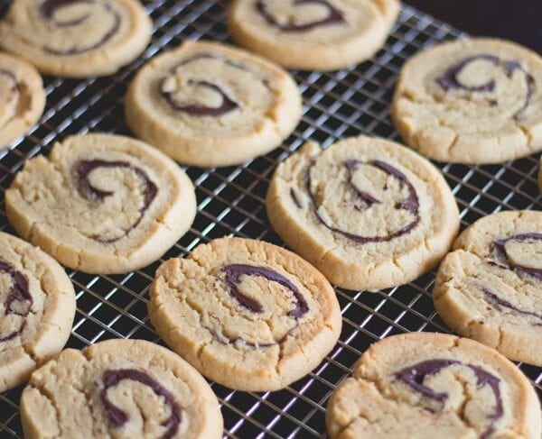 Peanut butter rollup cookies sitting on cooling rack after coming out of the oven.