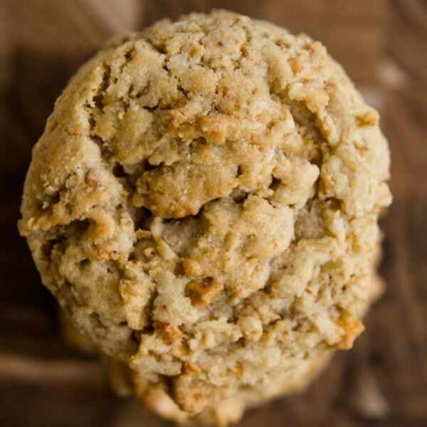 Top down view of light brown crunchy peanut cookies sitting on a wood cutting board