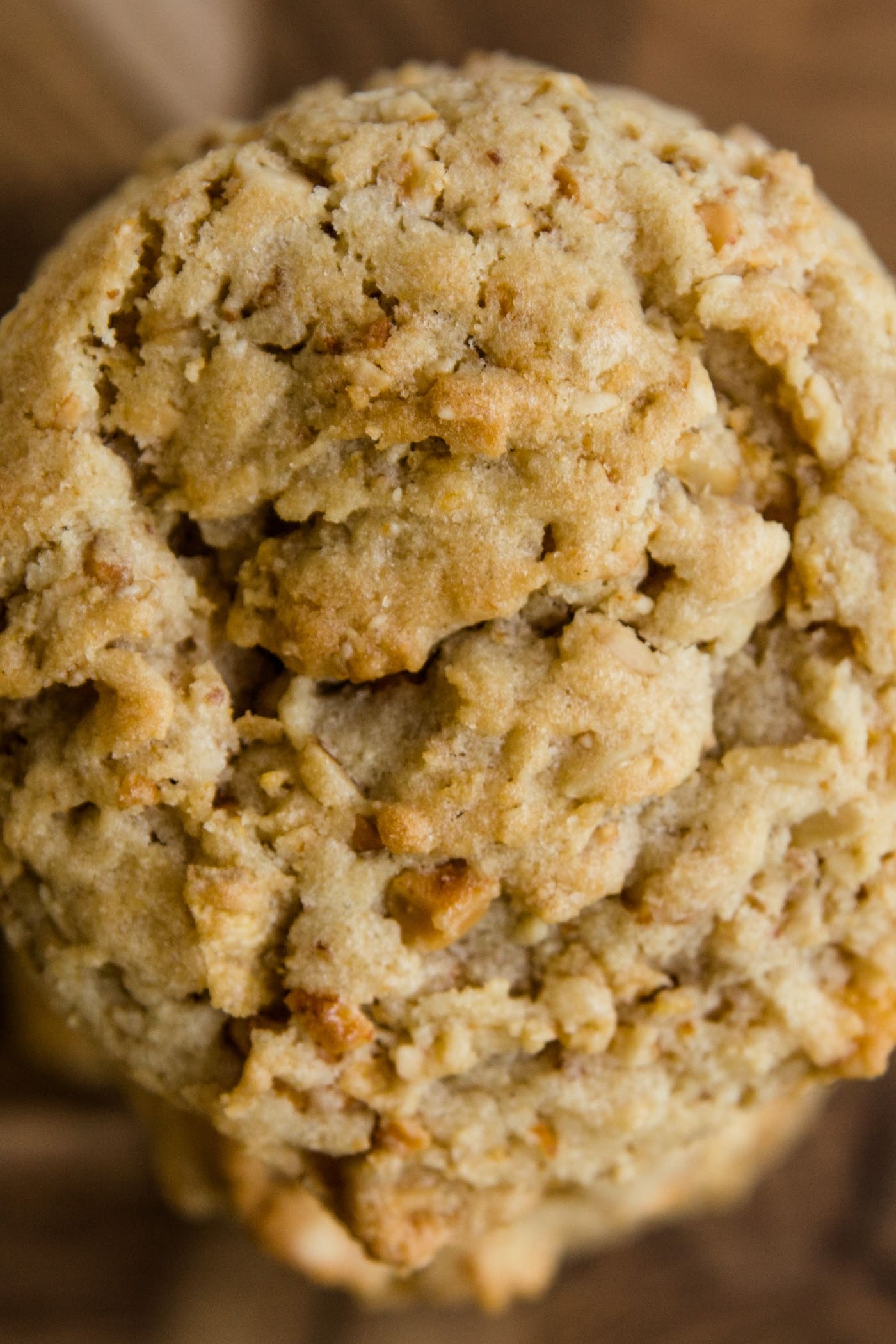 Top down view of light brown crunchy peanut cookies sitting on a wood cutting board