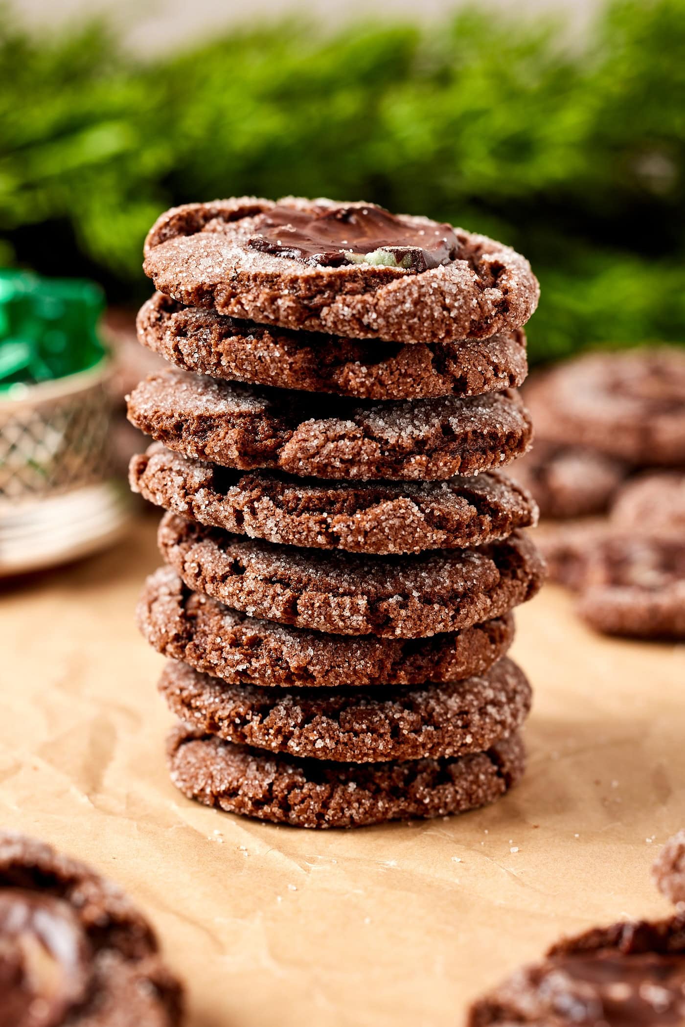 Stack of chocolate mint cookies sitting on a piece of parchment.