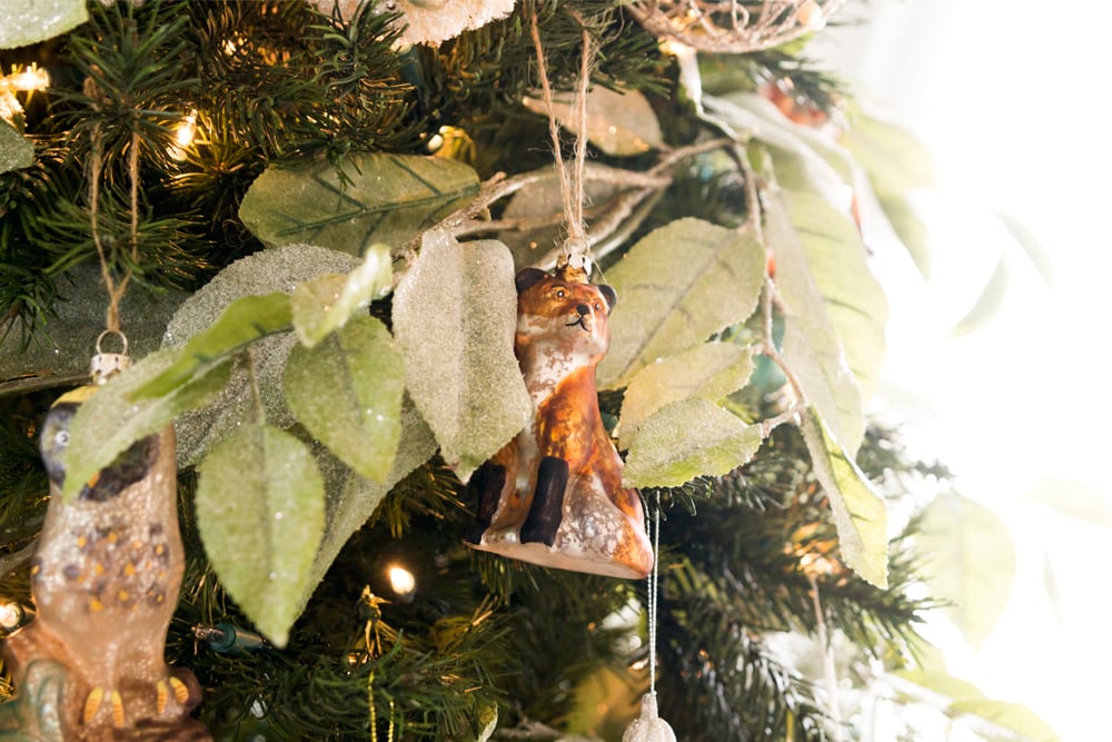 Christmas tree with ornaments all over including fox and leaf-like garland.