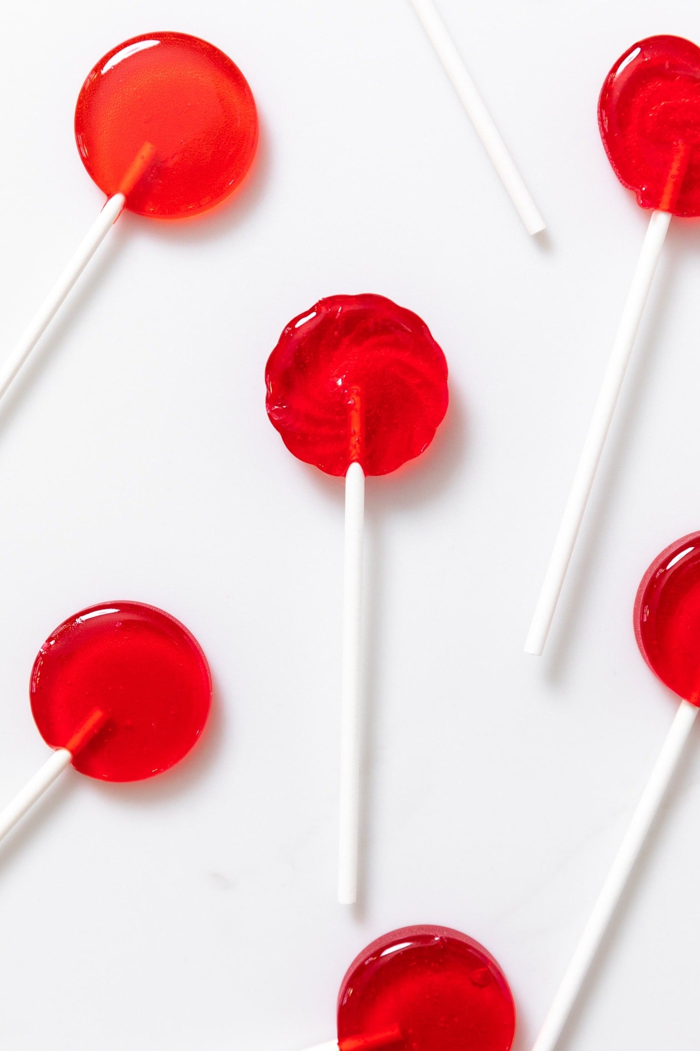 Red colored circular sucker sitting on white countertop
