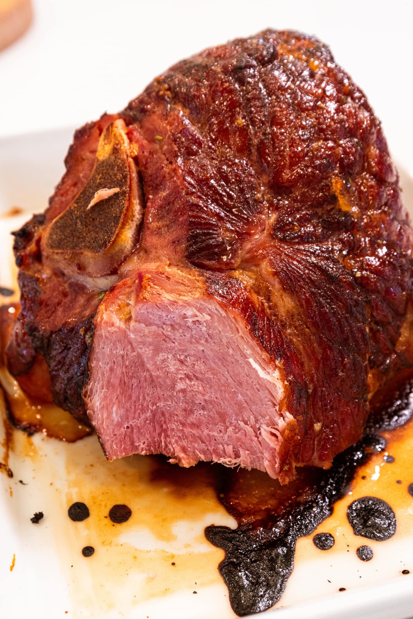 Piece of ham removed from the rest of the ham showing interior pink texture traditional for ham.