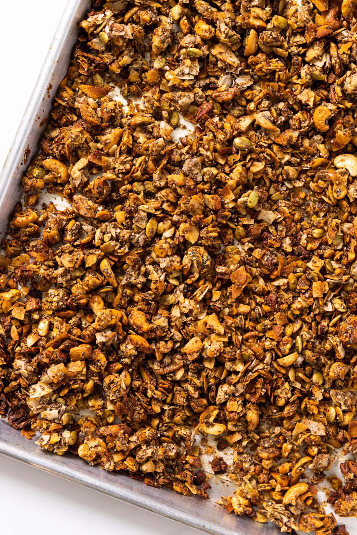 Top down view of pan filled with grain-free granola sitting on white countertop