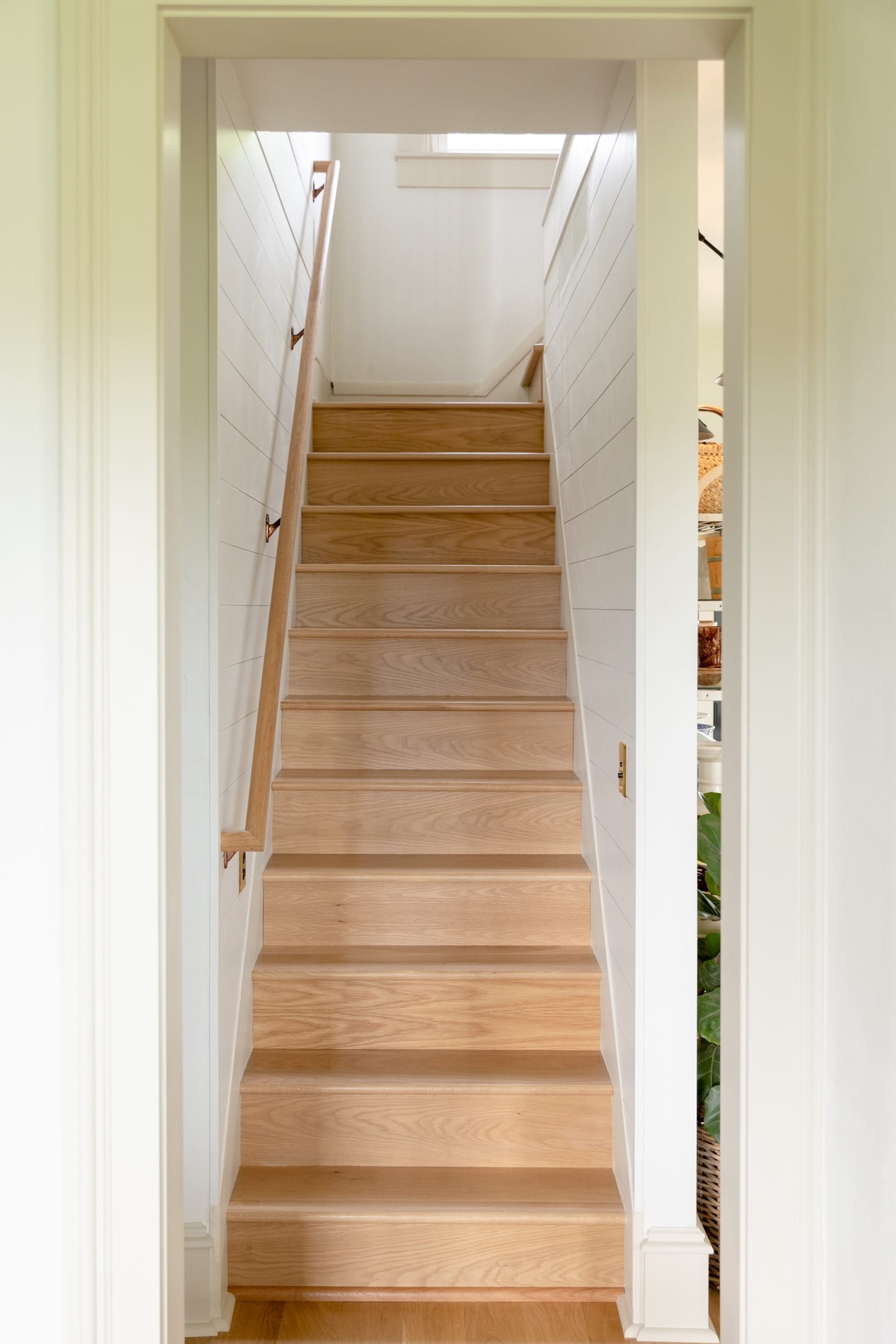 White oak stairs leading to a second floor