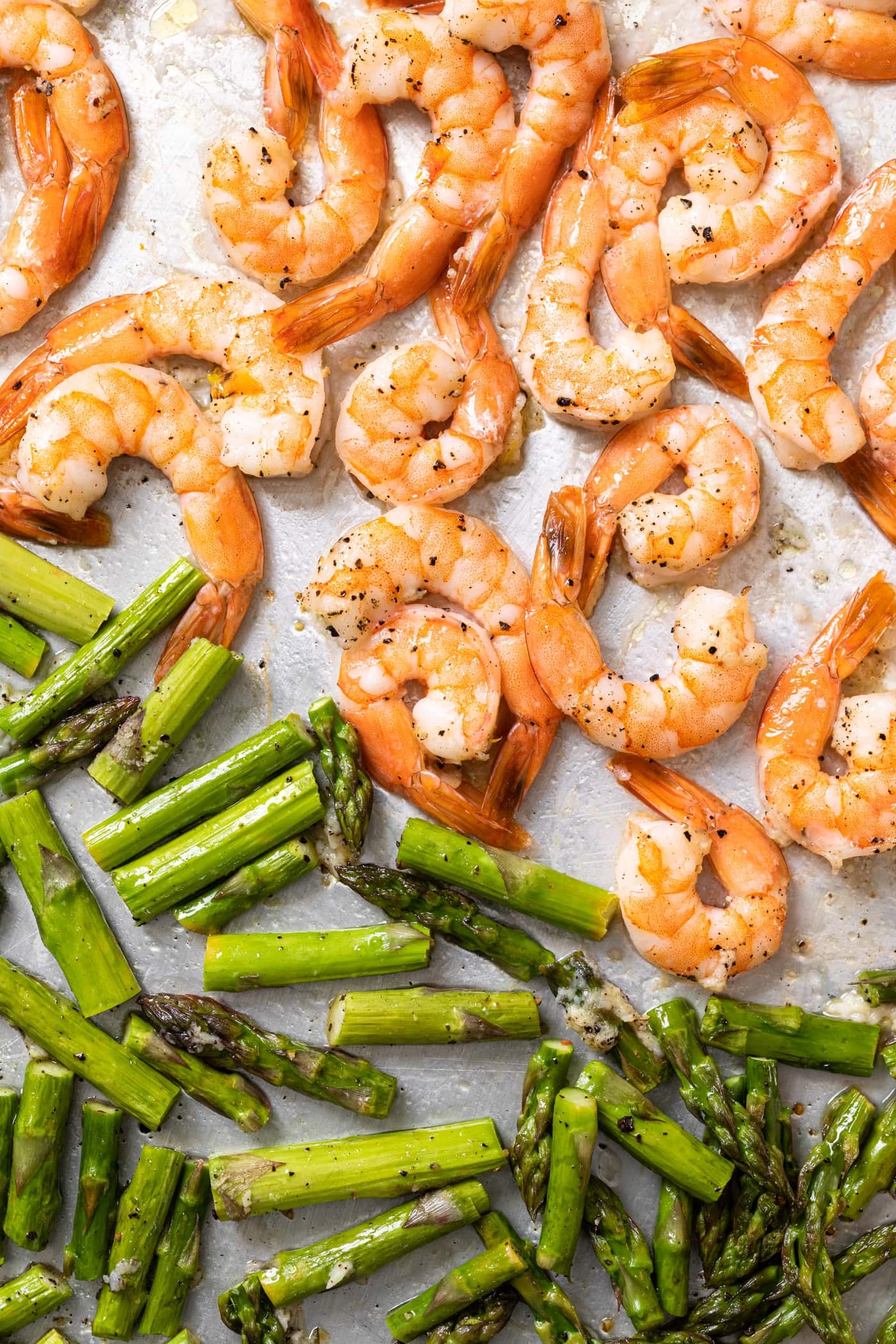 Top down view of sheet pan filled with roasted asparagus and shrimp