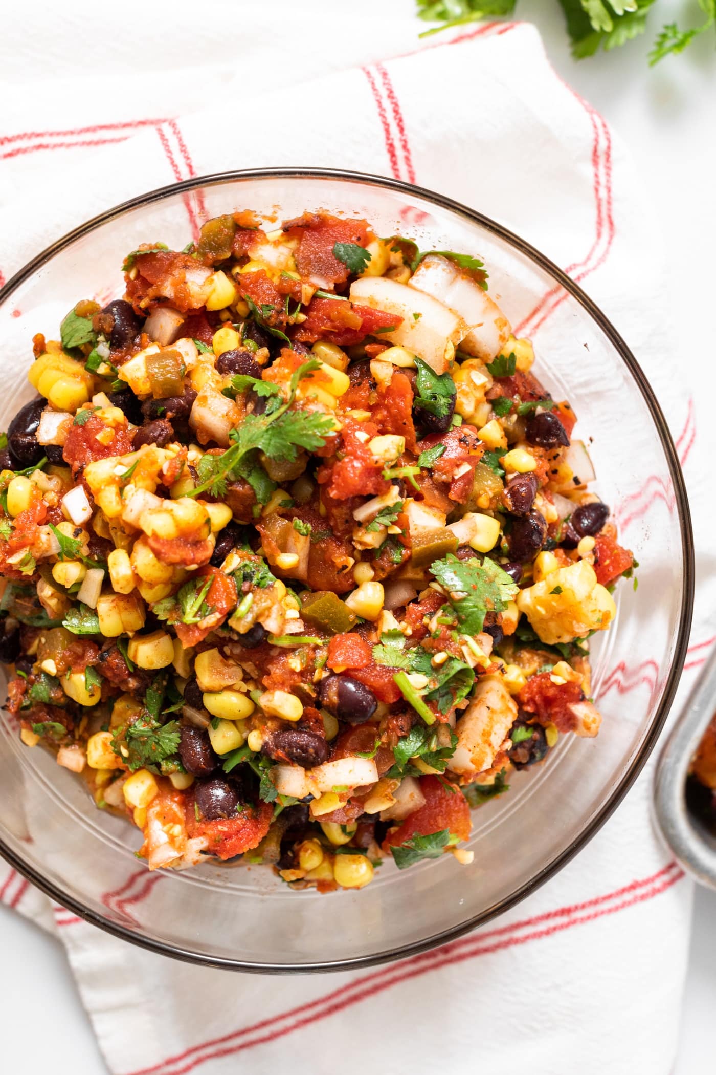 Top down view of glass bowl filled with corn and black bean salsa