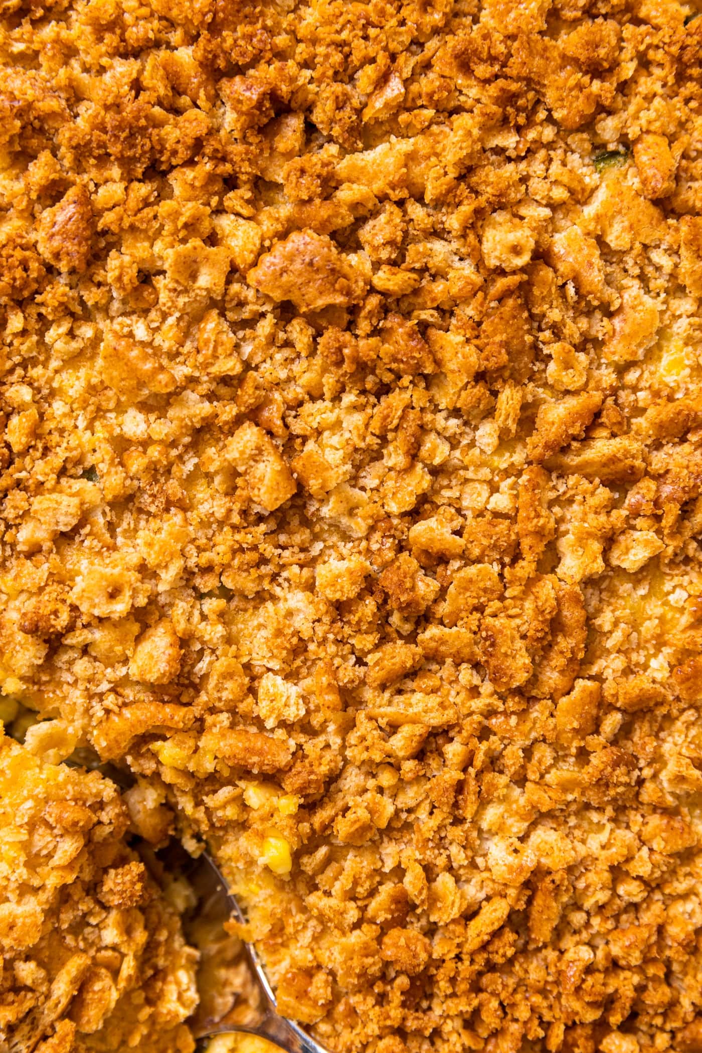 Top down view of golden colored cracker crust of corn spoon bread casserole
