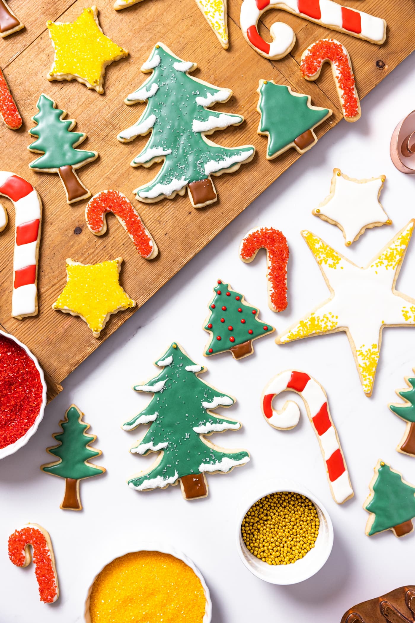 Top down view of Christmas sugar cookies after being decorated sitting on white countertop