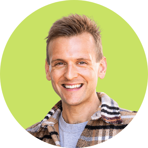 Kaleb Wyse wearing plaid coat in front of bright green background