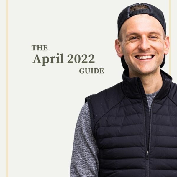 Kaleb Wyse wearing black best with ball cap on backwards standing in front of taupe background with words stating the month and year.