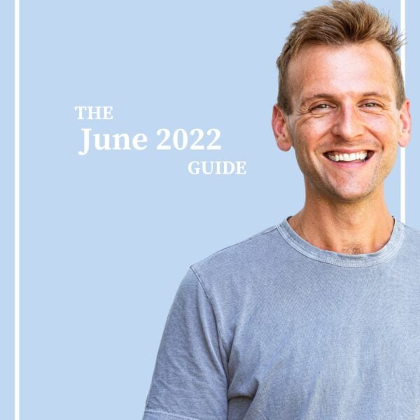 Tanned man with light blue shirt standing in front of light blue background with the words "The June 2022 Guide".