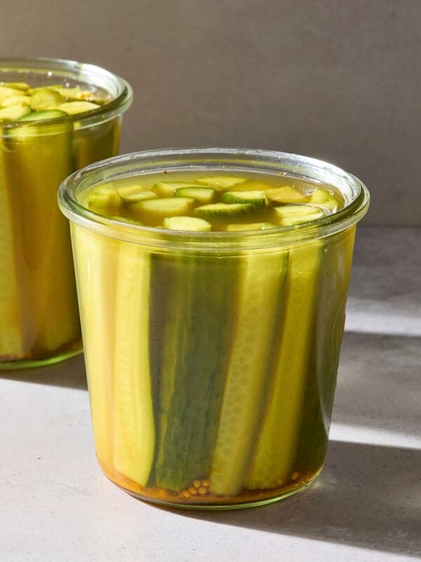 A jar filled with speared pickles.
