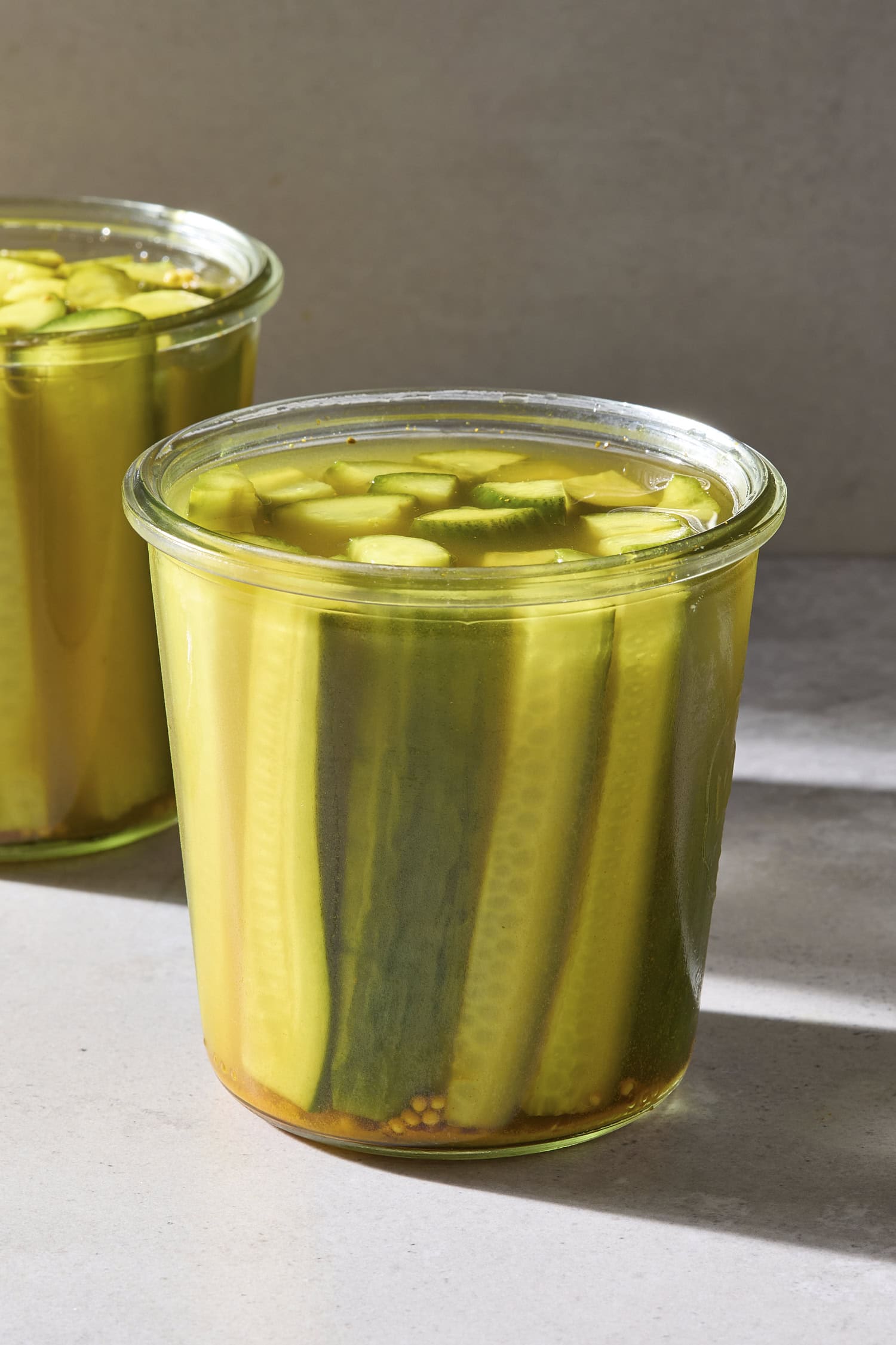 A jar filled with speared pickles.