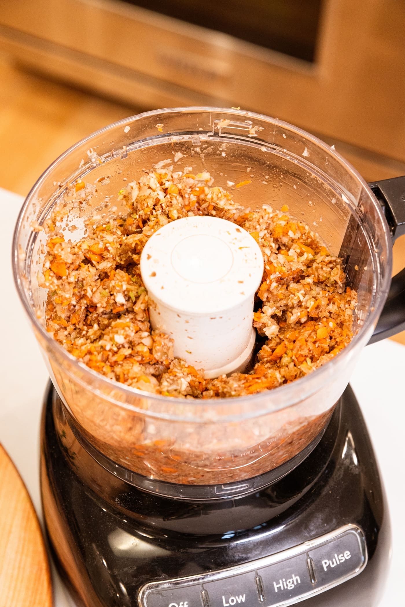 Bowl of food processor still sitting on food processor after being chopped by machine.