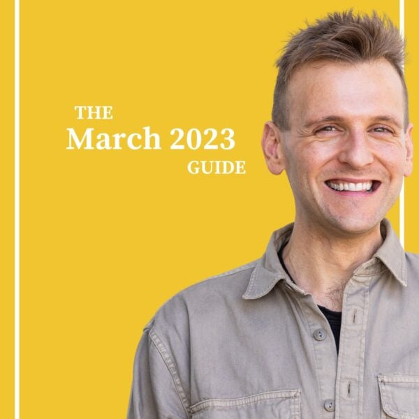 Kaleb Wyse wearing brown button down shirt standing in front of bright yellow background with the words "The March 2023 Guide".