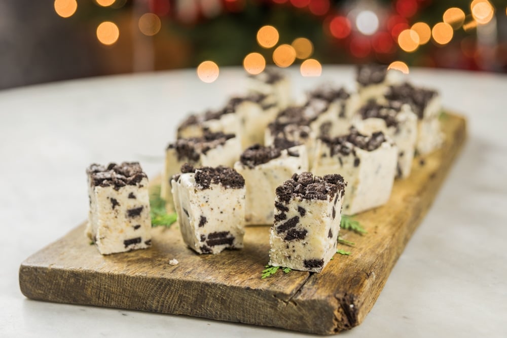 Pieces of white fudge sit on a serving block.