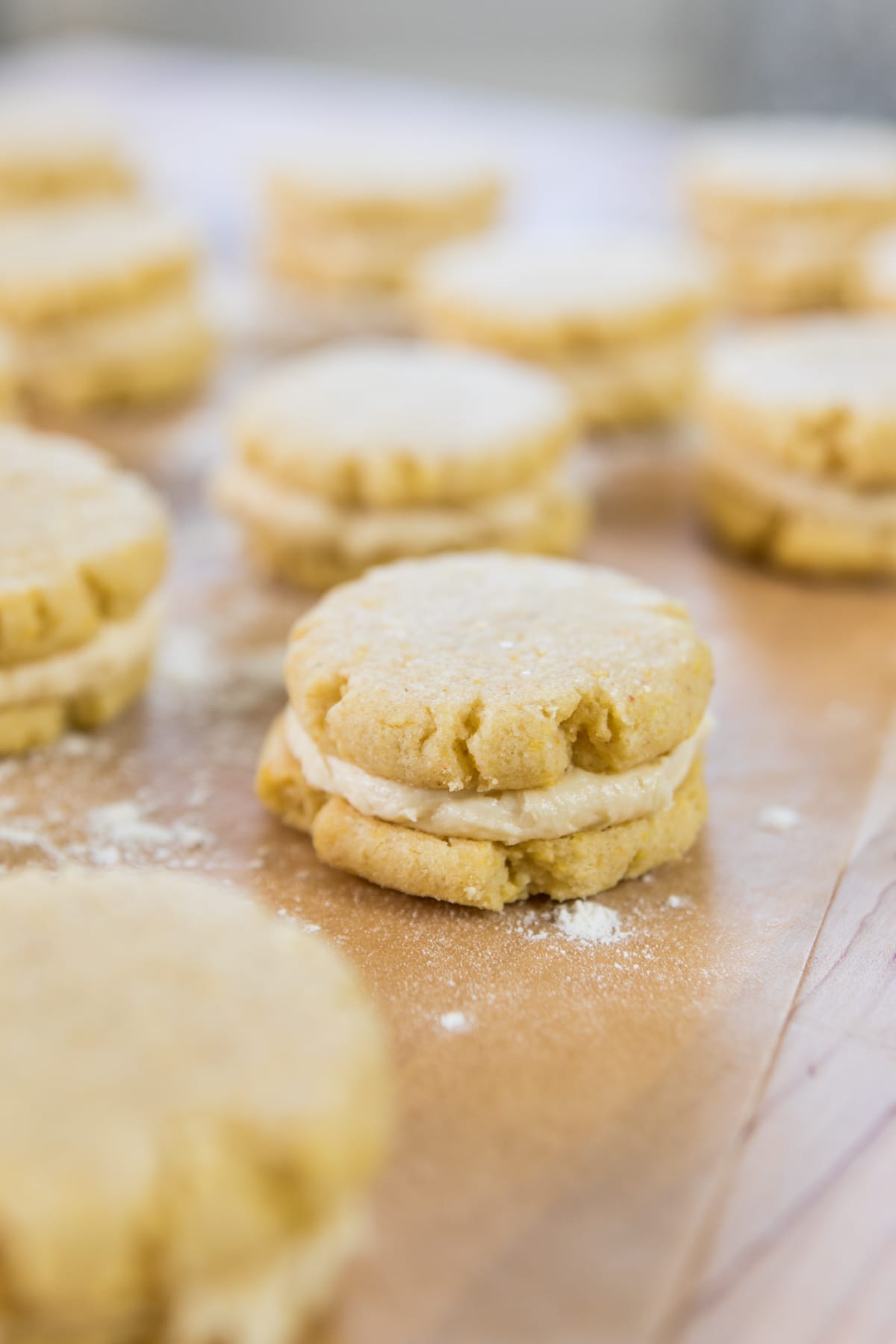 A sandwich cookie sits on a table.