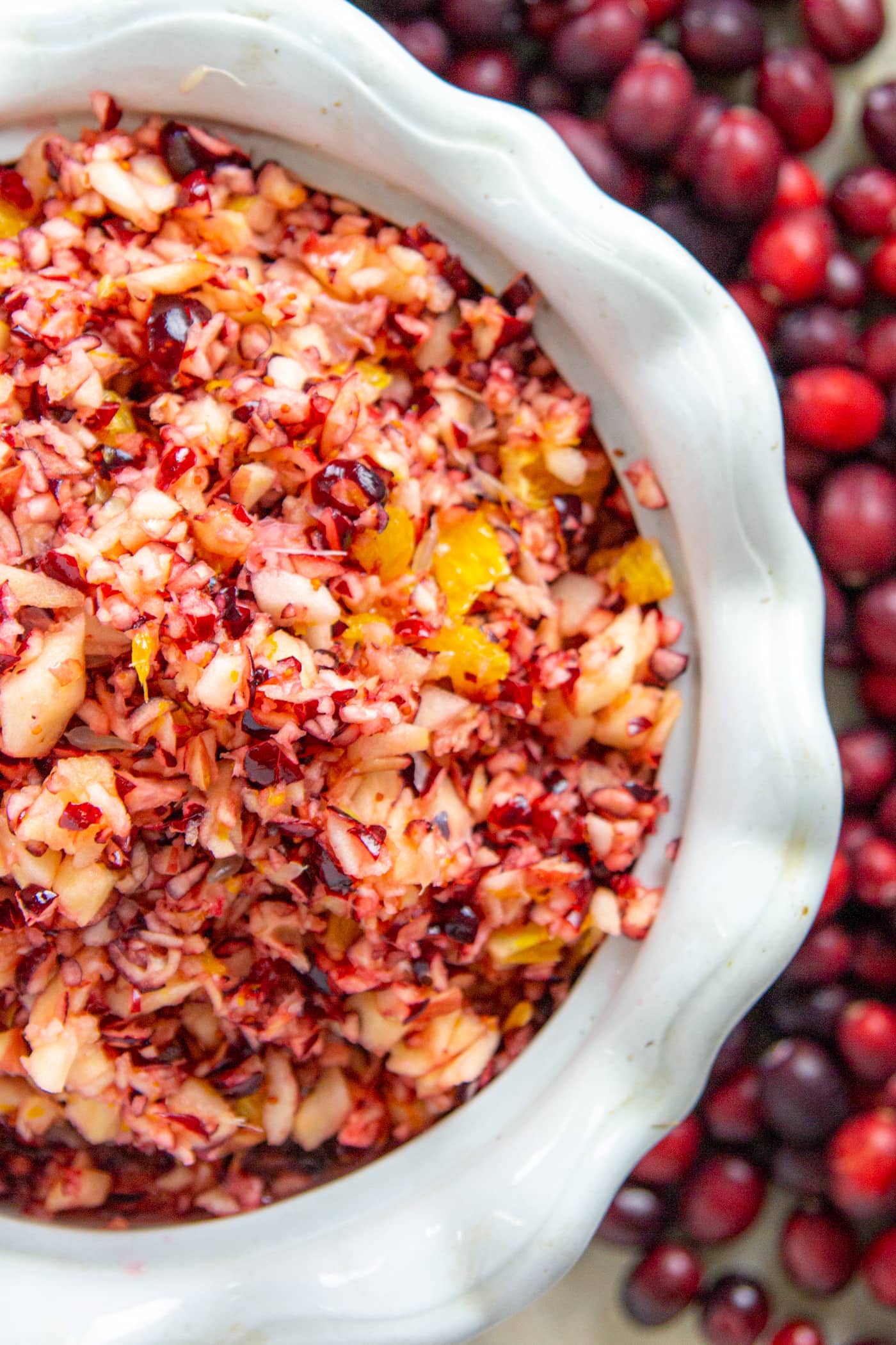 An overhead view of cranberry relish in a white decorative dish.