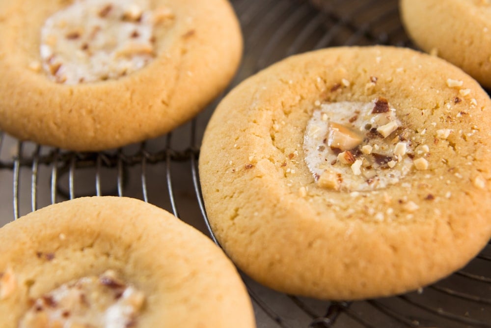 Cookies rest on a cooling rack.