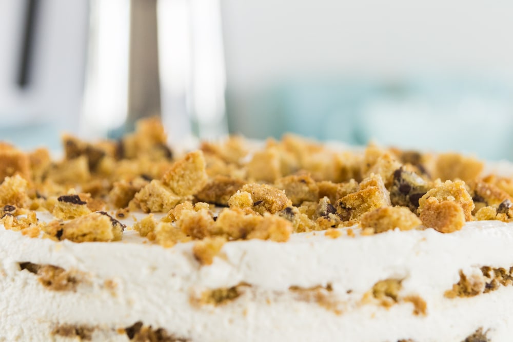 Crumbled cookies lie on top of a cookie-cake.