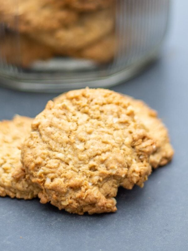 An oatmeal cookie sits on a table.