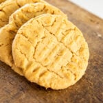 Cookies overlap each other in a row on a wooden block.