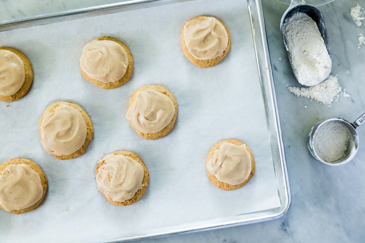 Cookies with icing on parchment paper.