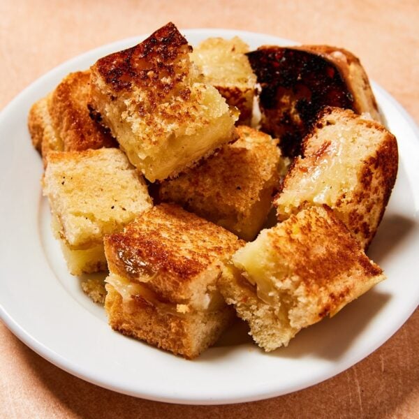 White plate filled with cubes of grilled cheese croutons.