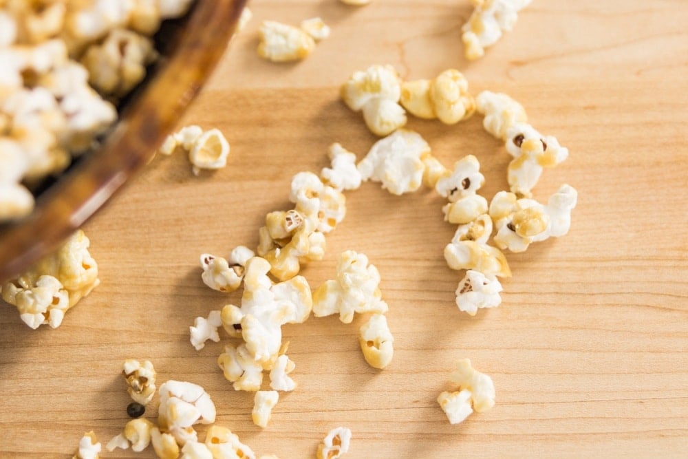 Caramel corn scatters across a table.