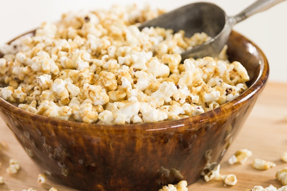 A serving bowl full of caramel corn.