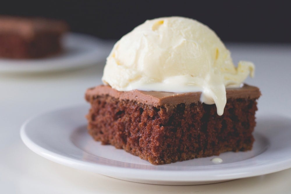 A slice of chocolate cake with ice cream on top.