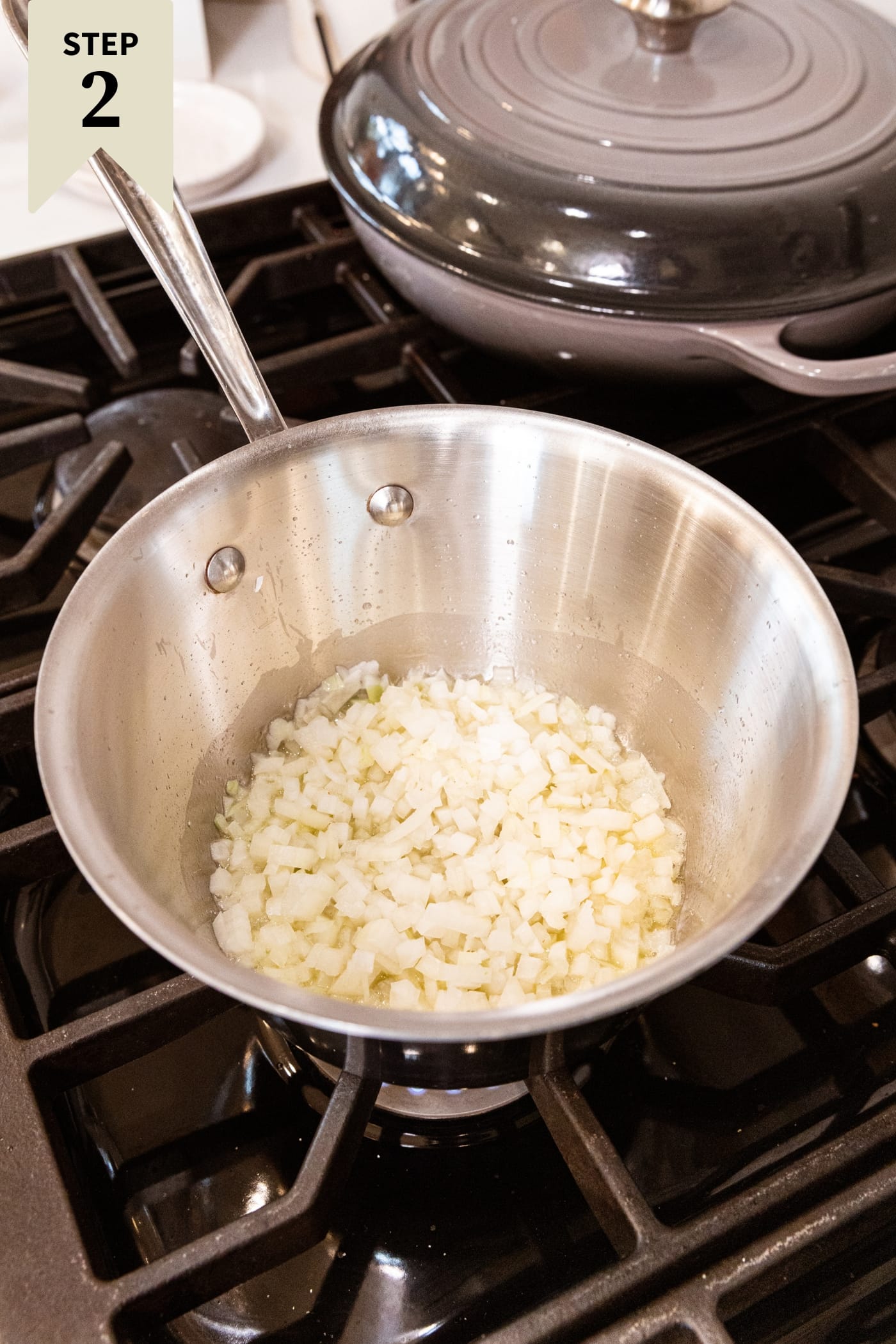 Metal saucepan with white mixture in the bottom cooking to form a cohesive mixture.