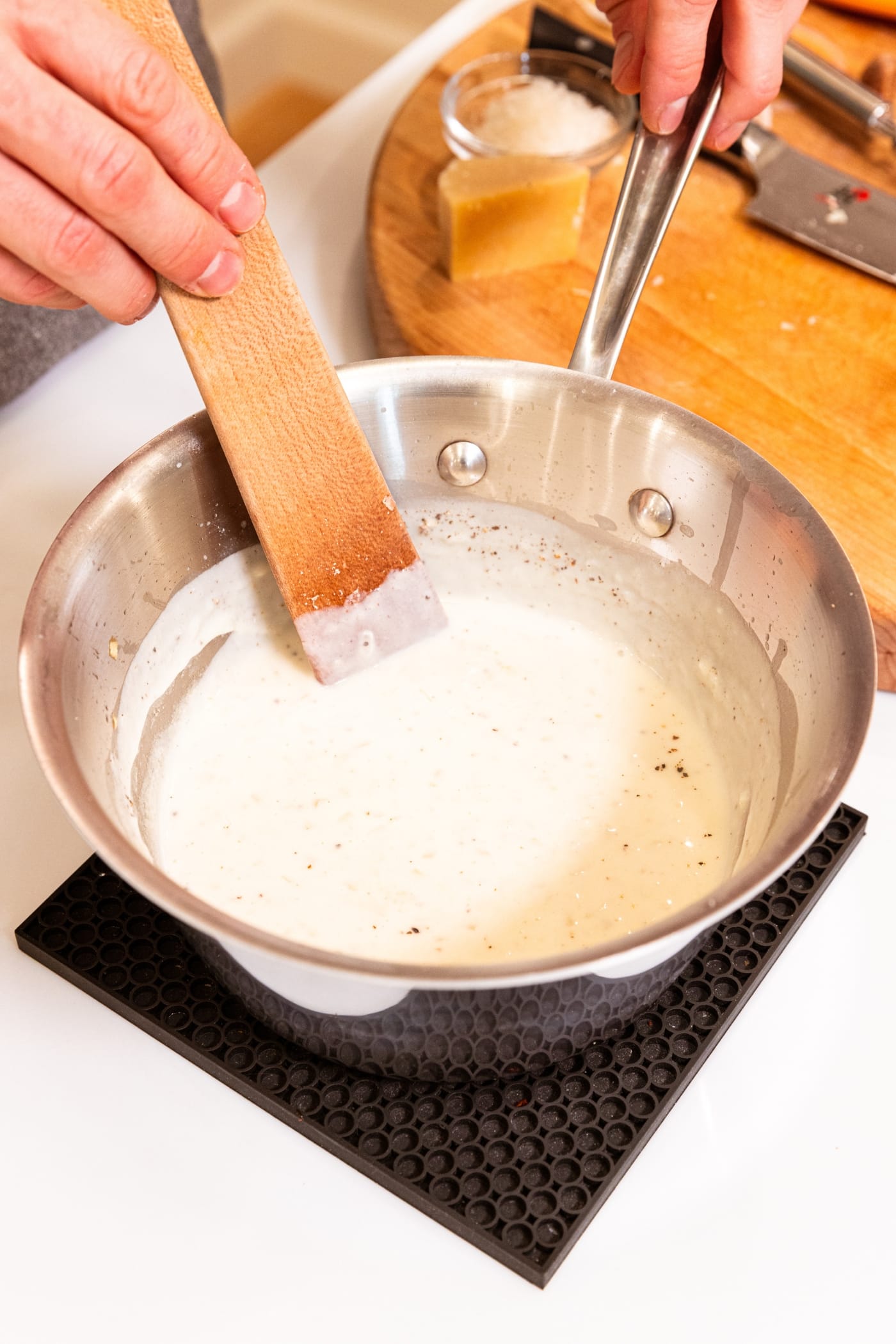Cauliflower au gratin mixture all mixed together in a metal saucepan before being added to the cauliflower.