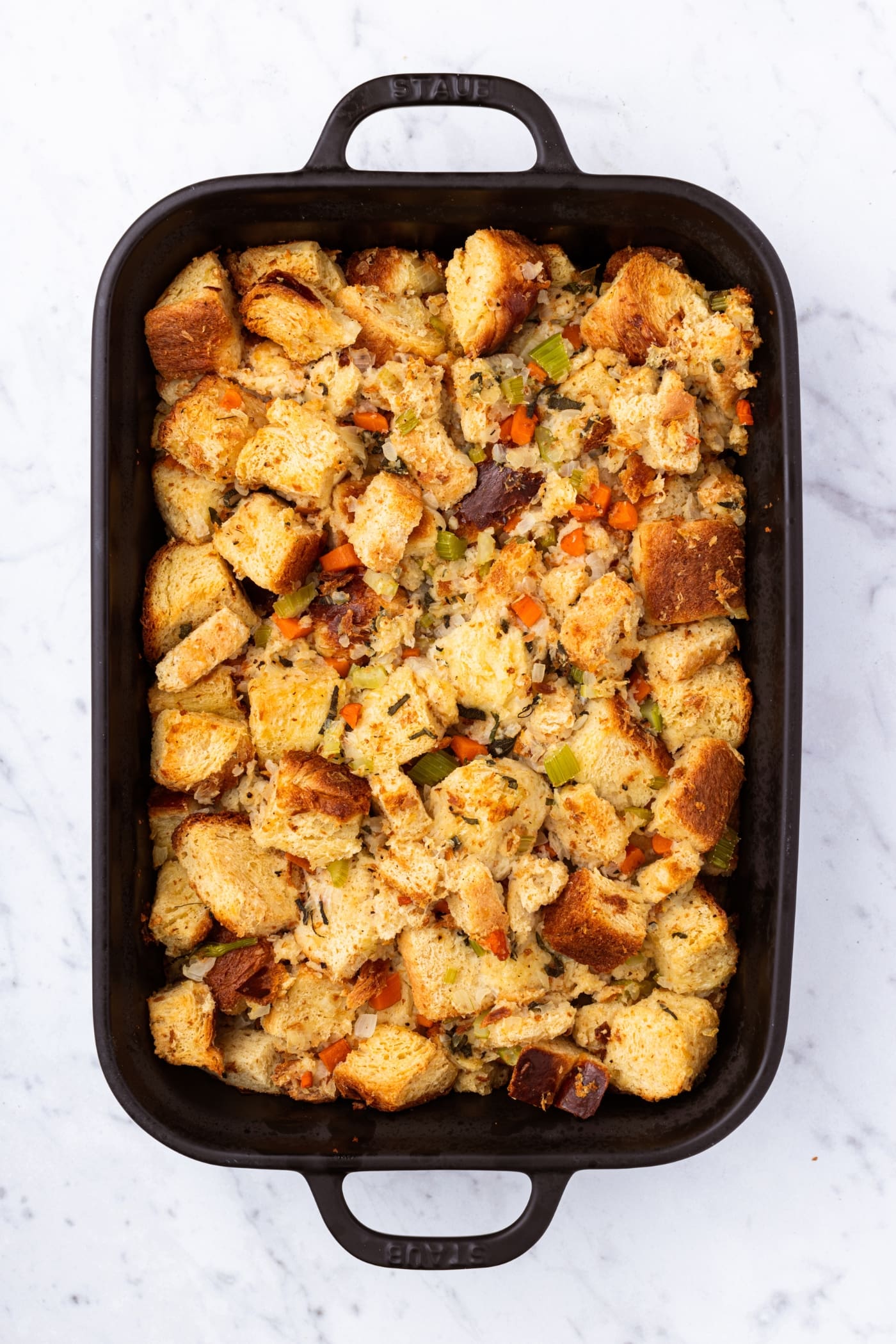 Bake pan filled with traditional stuffing right after coming out of the oven after baking.