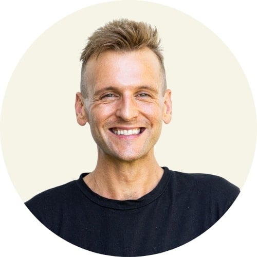 Kaleb Wyse standing in front of light gray background with black t-shirt.