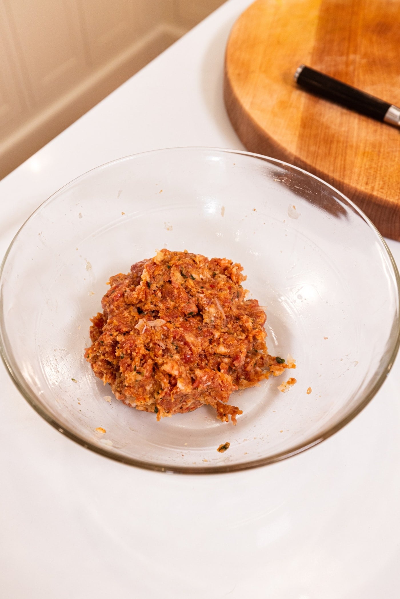 Mixture of sausage meat for puff pastry bites all in a glass bowl.