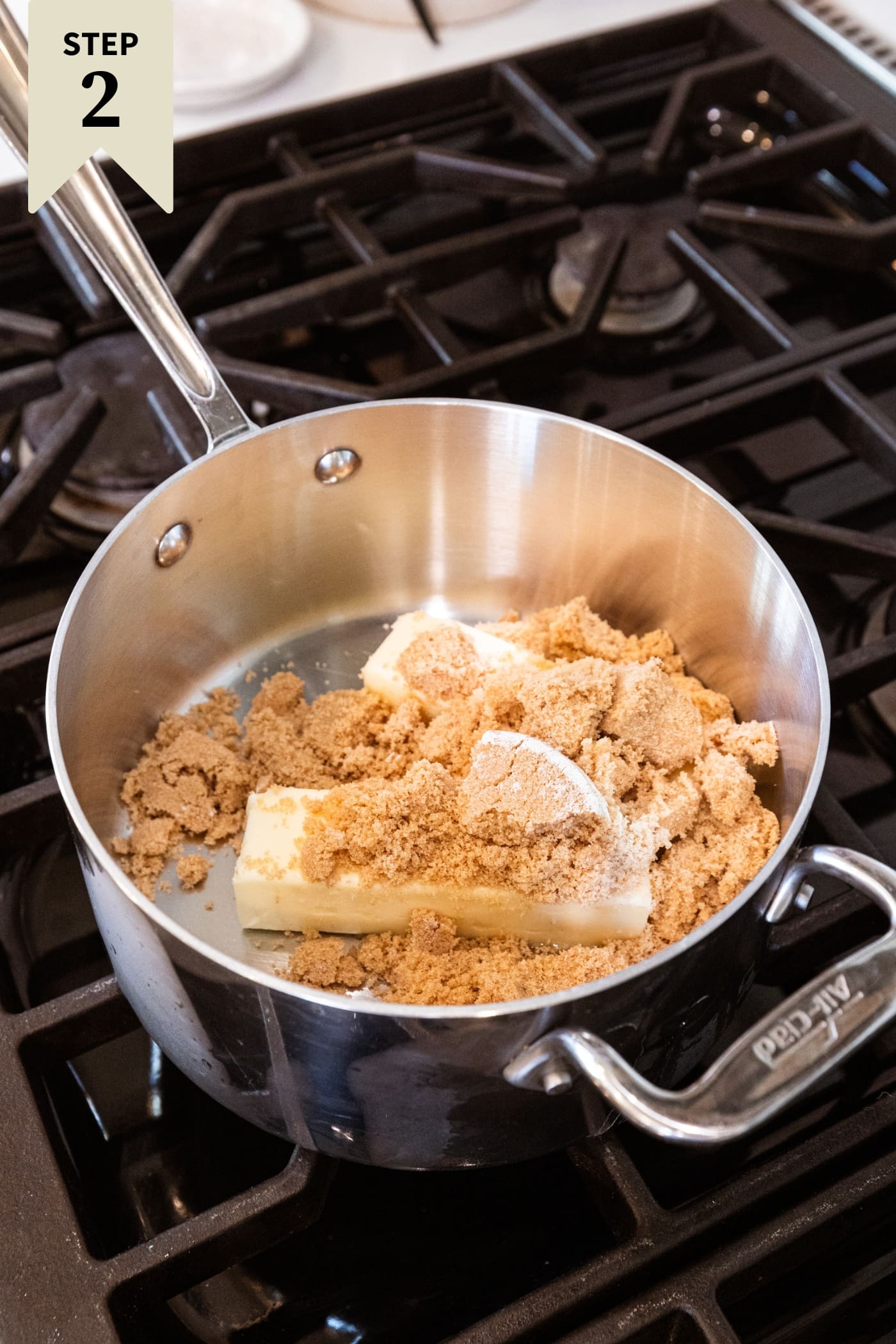 Butter and brown sugar melting in a saucepan on the stovetop.