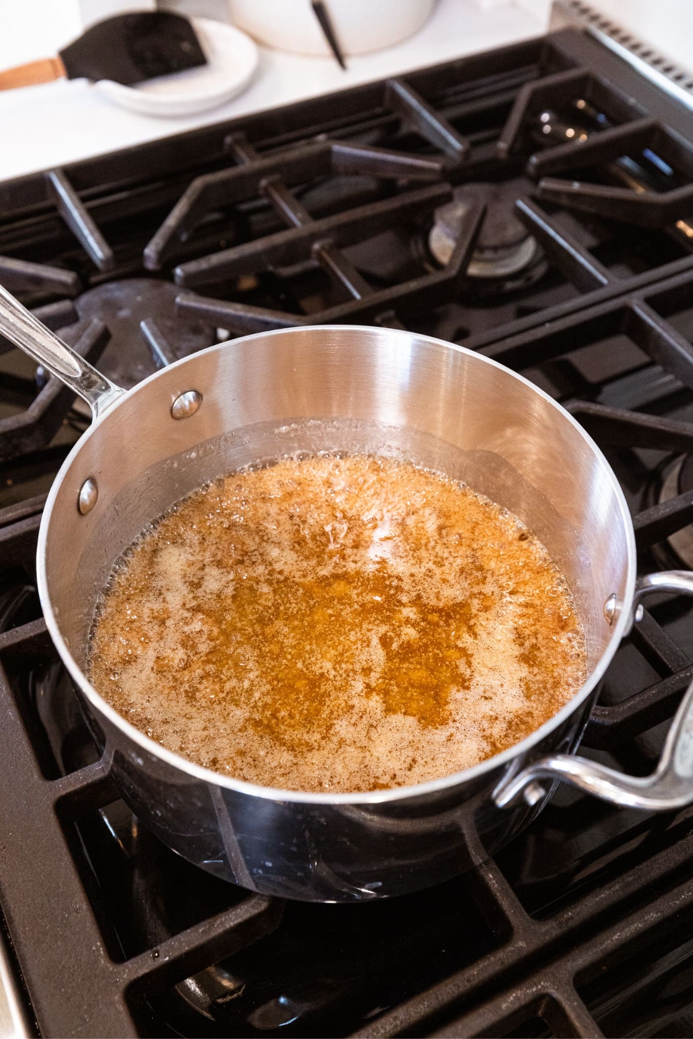 Saucepan with melted caramel mixture on the stovetop.