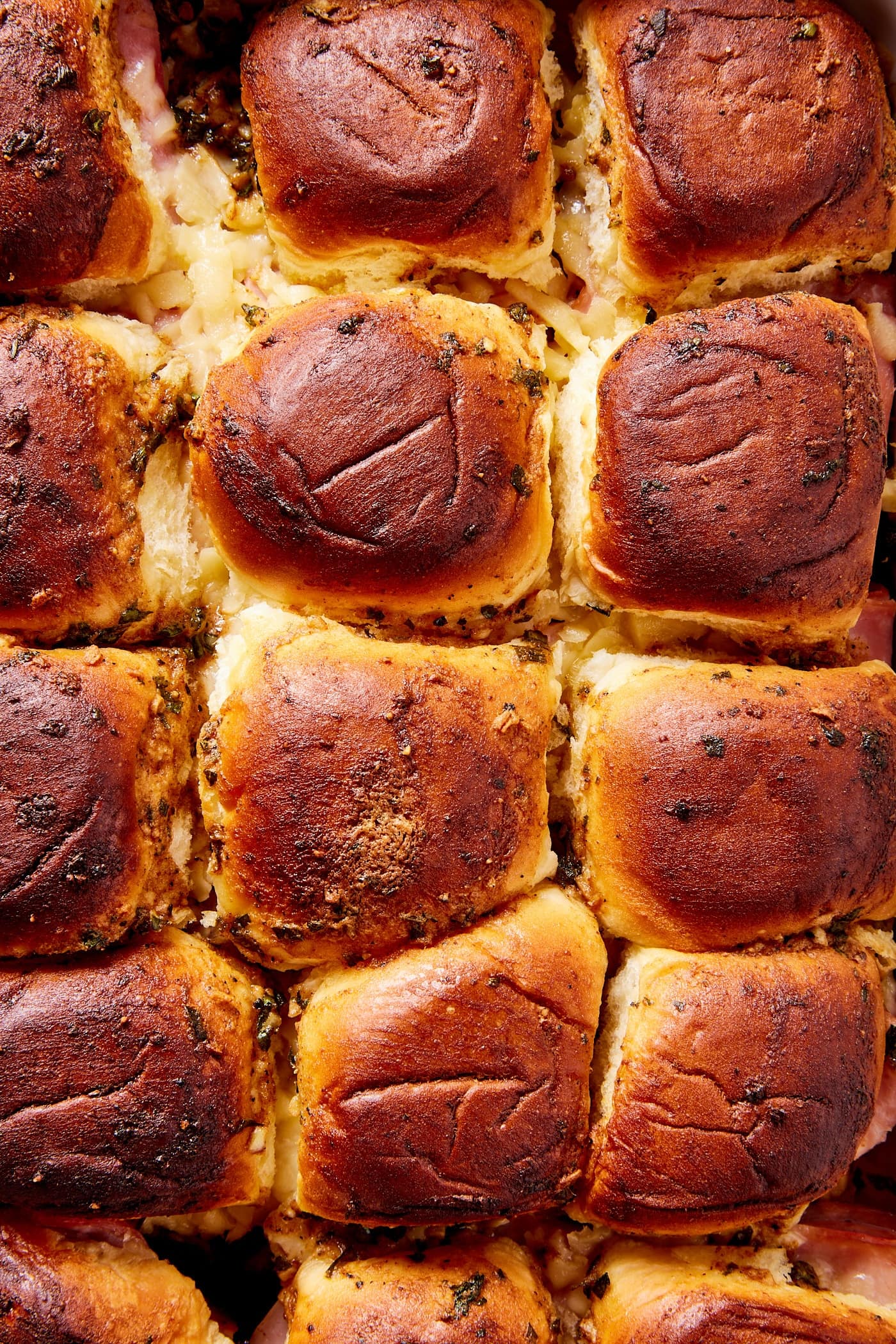 Top of sweet rolls after being baked in the oven with butter brushed over the top making the tops glisten.
