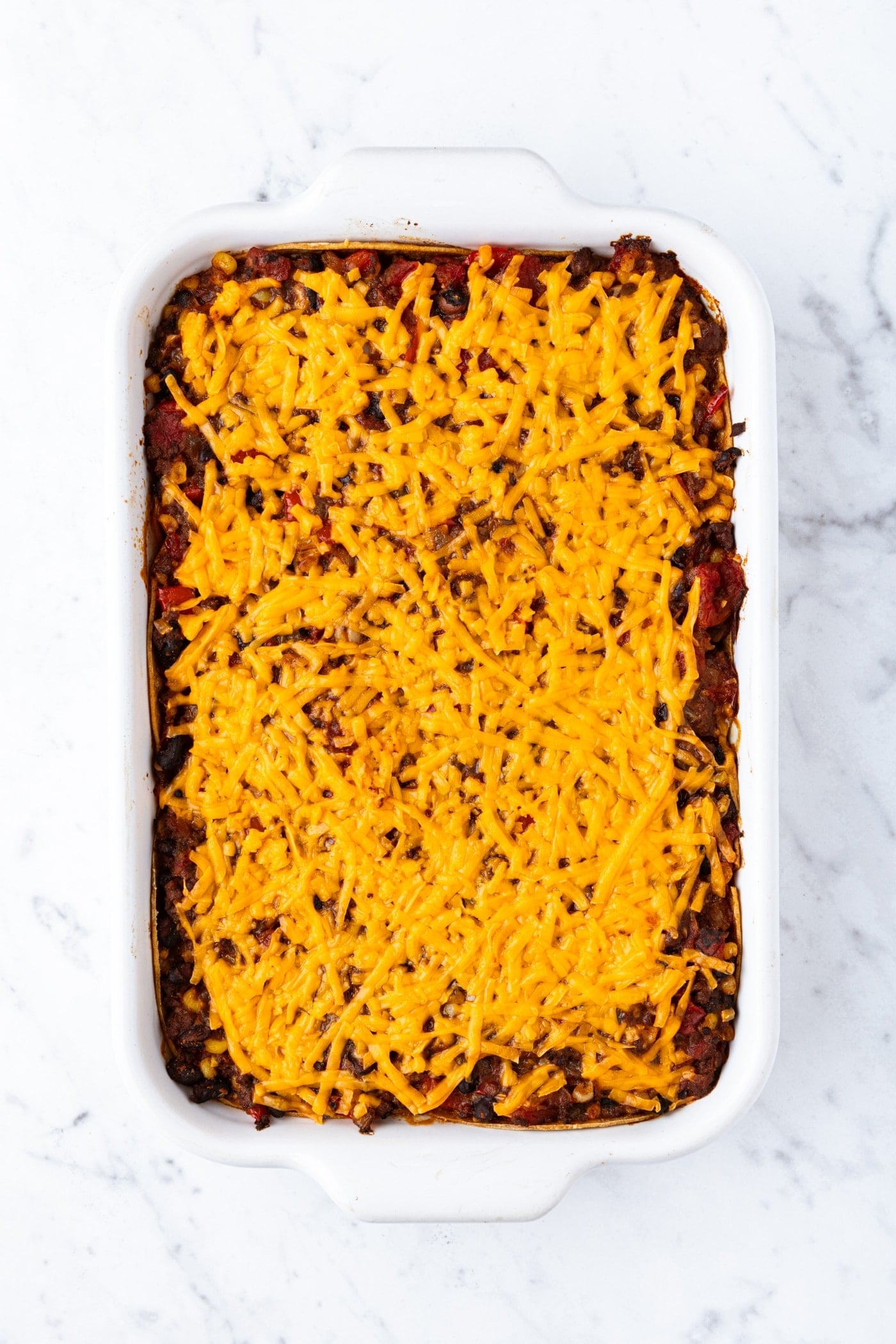 Baked loaded taco squares casserole with melted cheese all over the top.