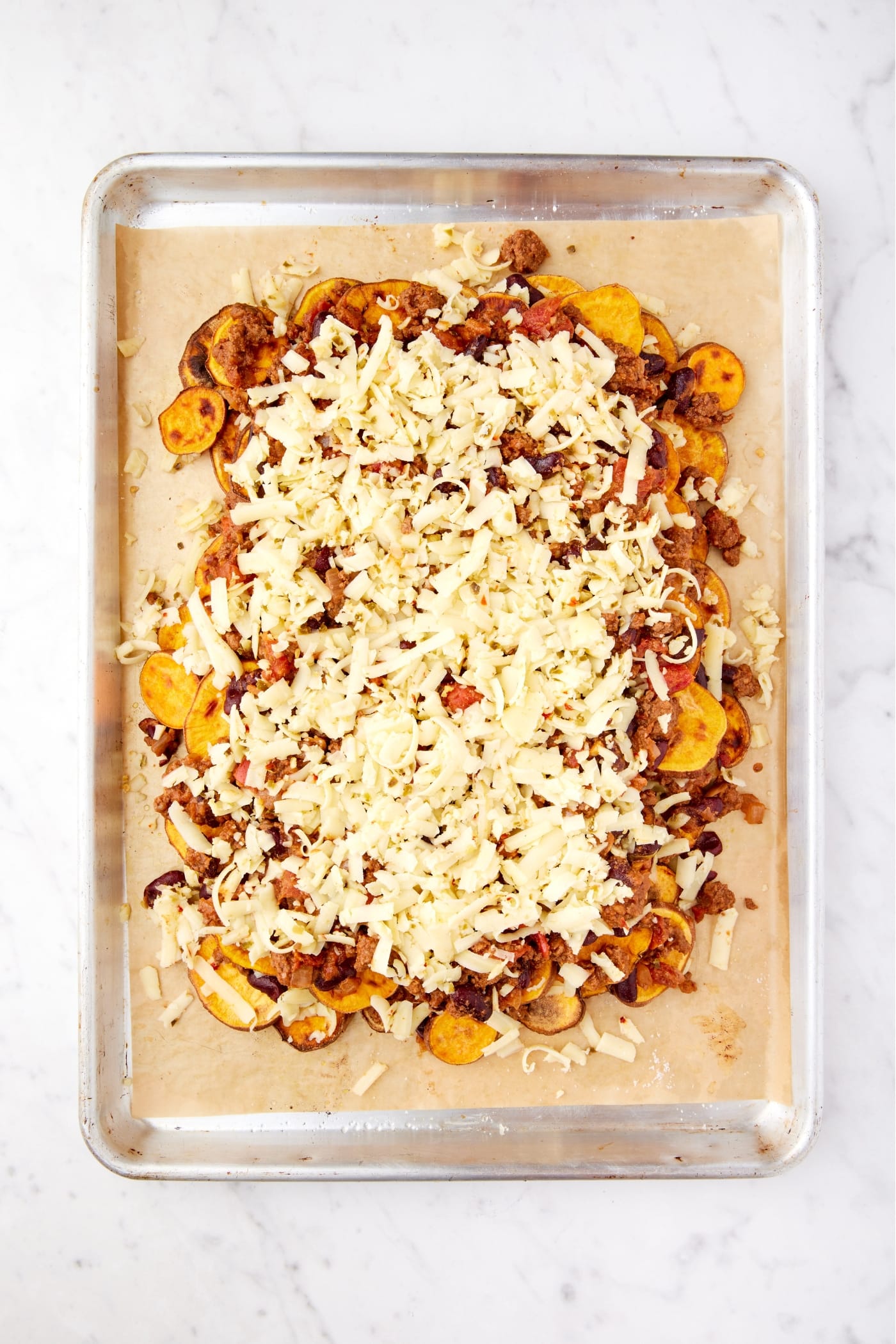 Layers of sweet potato, chili, and cheese all right before going into the oven to bake.