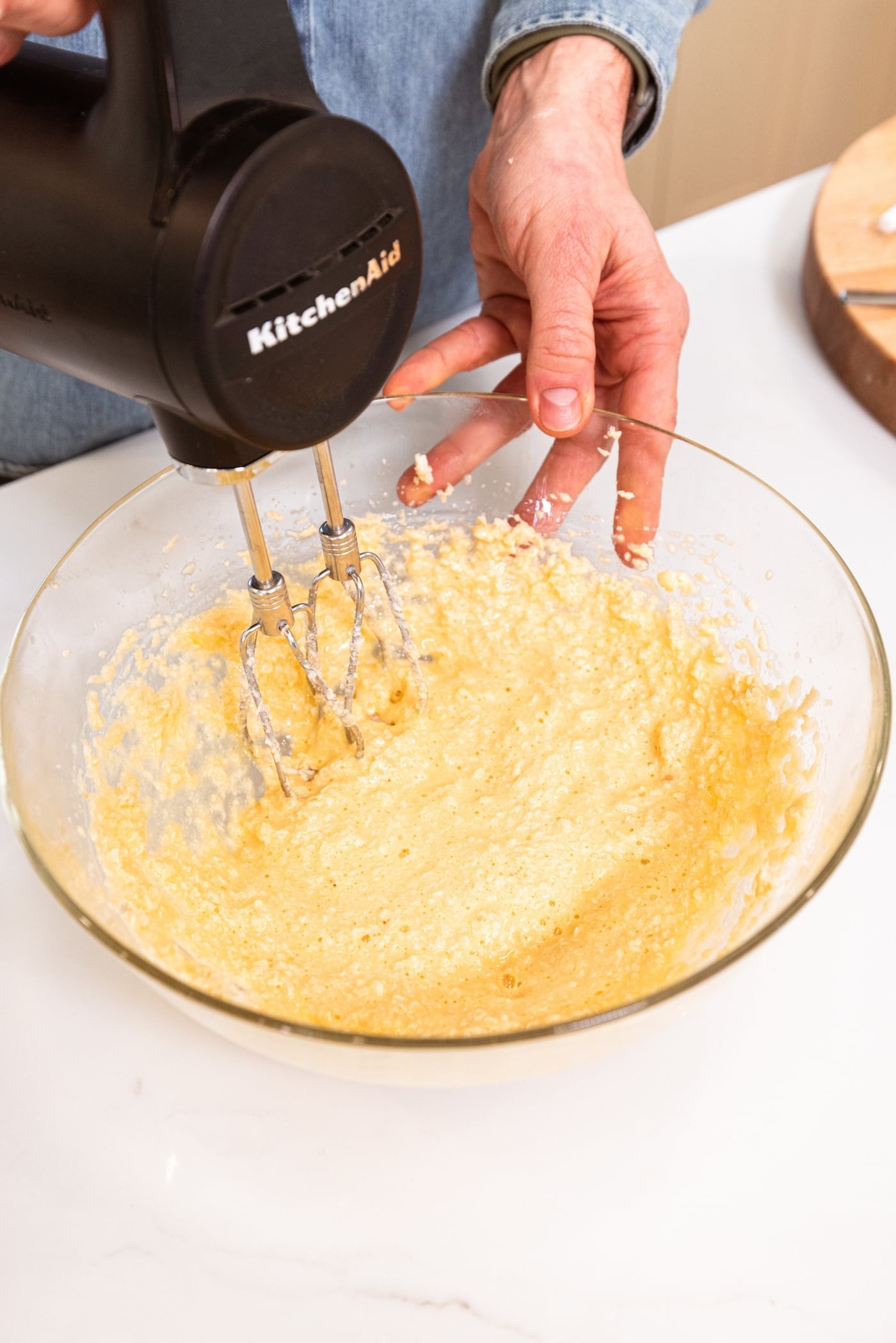 Hand mixer mixing together eggs with creamed sugar mixture.