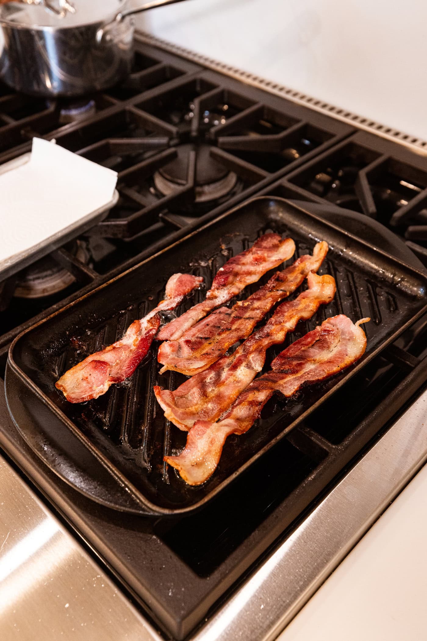Grill pan on the stovetop after being cooked right before being removed.