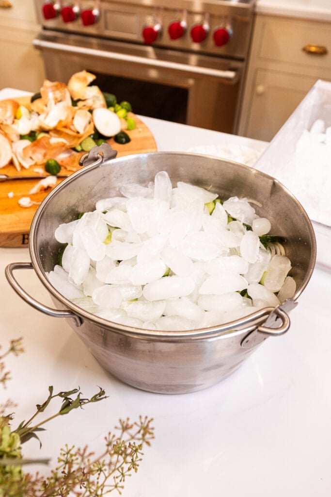 Ice sits on sliced cucumbers.