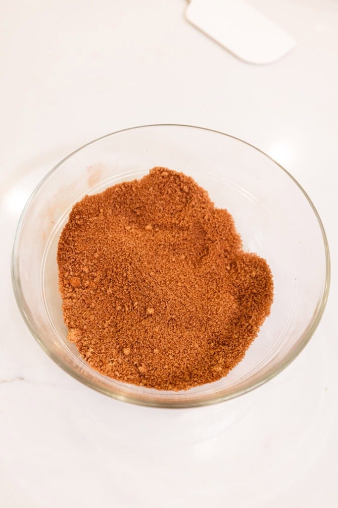 A brown sugar and cinnamon mixture sits in a bowl.