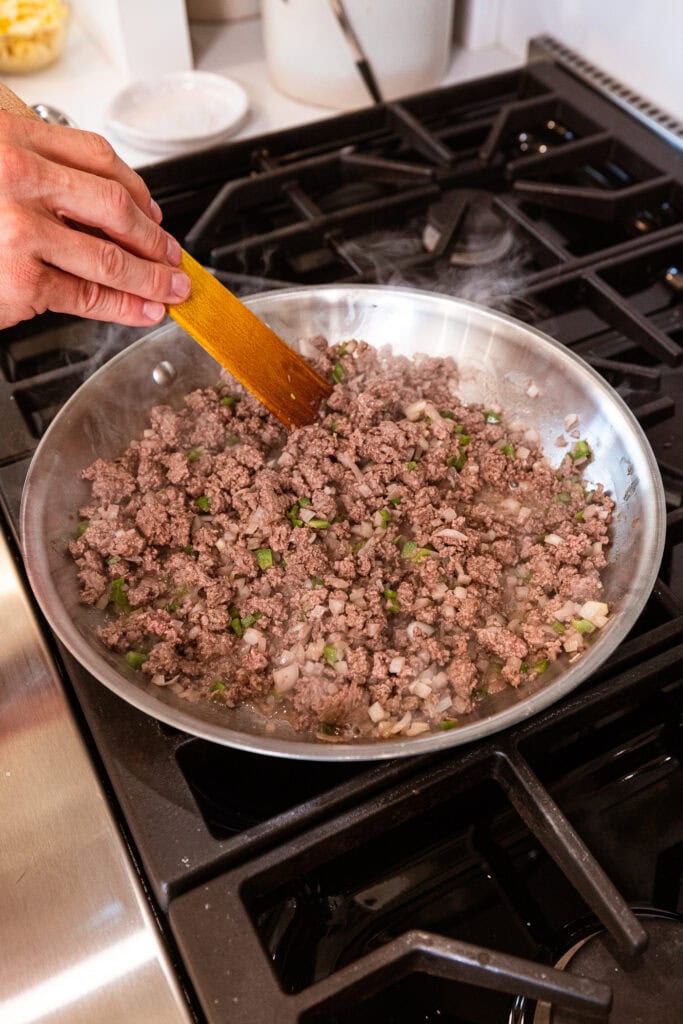 Ground beef browns on the stove.